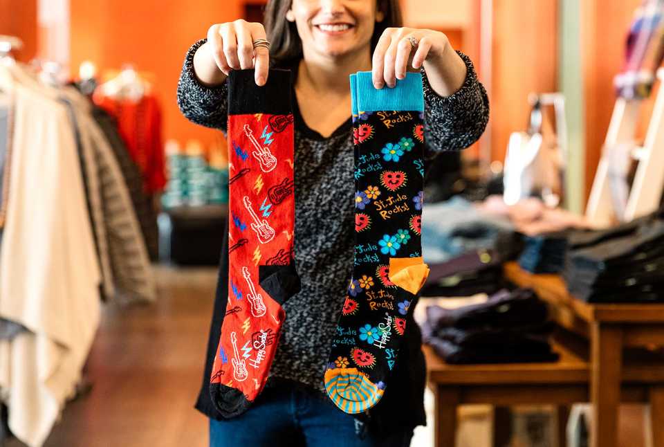 <strong>Julie Lansky owner of Lansky Bros. clothing company holds their new line of "St. Jude Rocks" socks in their store inside the Peabody. Lansky Bros. and Oak Hall teamed up to sell the socks, and a portion of proceeds go to St. Jude.</strong> (Houston Cofield/Daily Memphian)