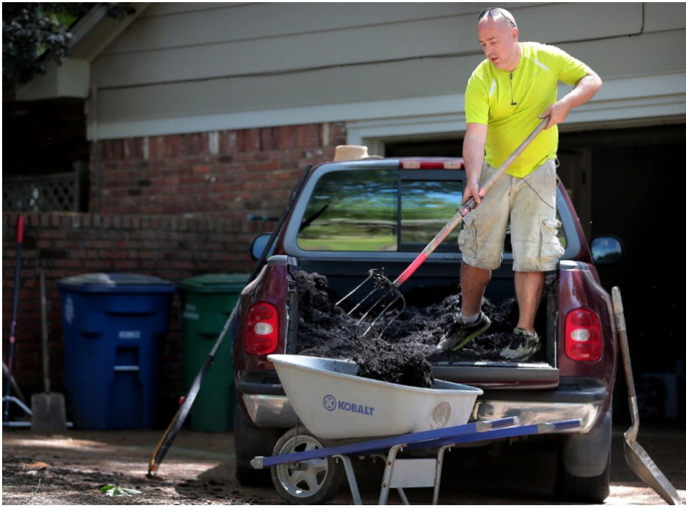 <strong>Scott Briggs shovels mulch out of the back of his borrowed truck while planting hydrangeas at a client&rsquo;s home in East Memphis on April 11, 2020.</strong><span>&nbsp;(Jim Weber/Daily Memphian file)</span>
