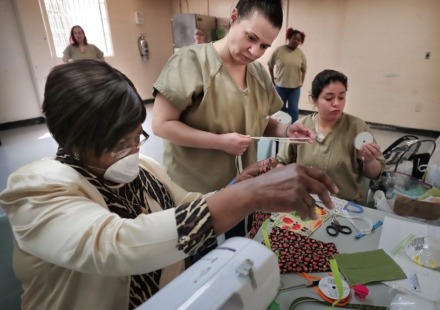 <strong>Corrections program specialist Gloria Phillips (left) works with Allison Sherwood and Savannah Sauceda (right) as inmates at the Shelby County Correctional Center learn how to make fabric masks on April, 17, 2020, in the midst of the coronavirus pandemic. </strong>(Jim Weber/Daily Memphian)