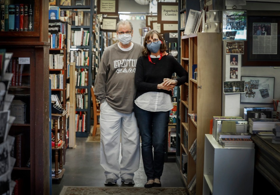 <strong>Burke&rsquo;s Bookstore owners Corey and Cheryl Mesler stand among their books on Thursday, April 16, 2020 in Cooper-Young. The bookstore has been open since 1875, and is now hand-delivering books to customers.</strong> (Mark Weber/Daily Memphian)