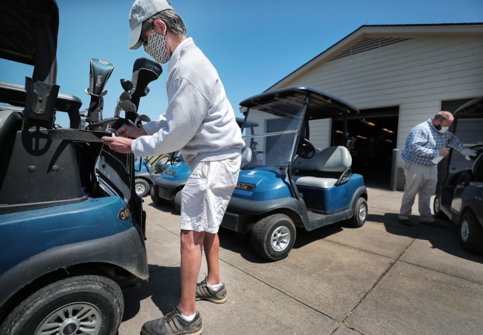 <strong>Rick Mason loads up his clubs as golfers return to the Links at Whitehaven golf course on April 18, 2020, on a trial basis to test whether golfers would adhere to social distancing requirements during play. </strong>(Jim Weber/Daily Memphian)