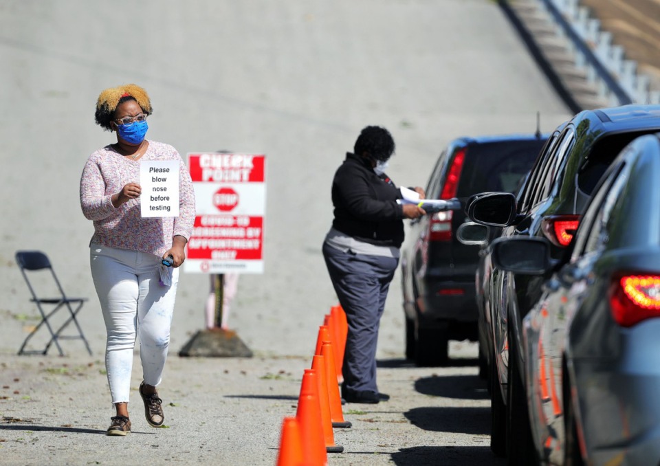 <strong>A health care worker reminds patients to blow their noses before getting tested at Christ Community Health's drive-thru COVID-19 testing site in Whitehaven April 13, 2020.</strong> (Patrick Lantrip/Daily Memphian)