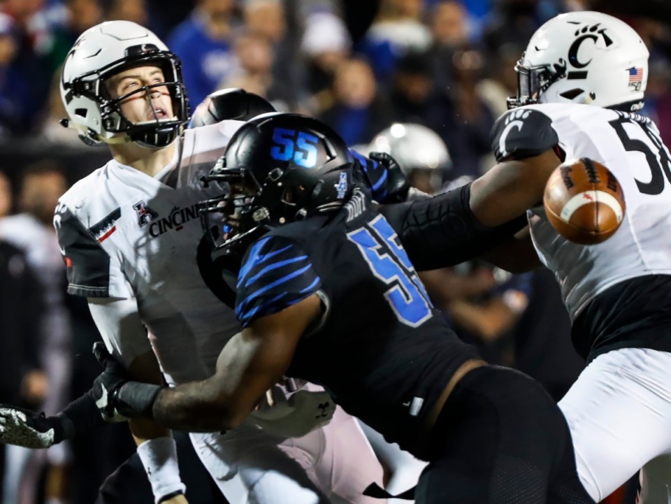 <strong>Memphis defender Bryce Huff (55) causes a fumble while sacking Cincinnati quarterback Ben Bryant (left) during action Nov. 29, 2019, at the Liberty Bowl Memorial Stadium. Huff is awaiting the 2020 NFL Draft.</strong> (Mark Weber/Daily Memphian file)