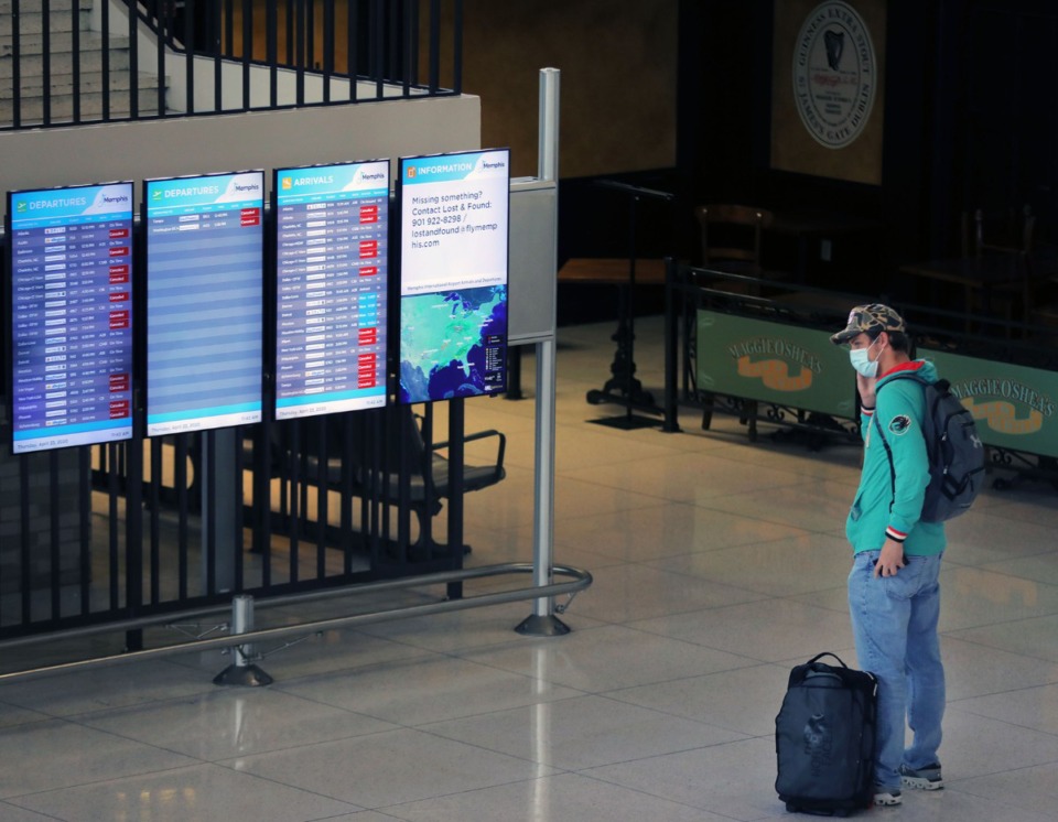<strong>A lone passenger checks the flight information display system at Memphis International Airport on Thursday, April 23. The display showed roughly two dozen canceled flights.</strong> (Patrick Lantrip/Daily Memphian)