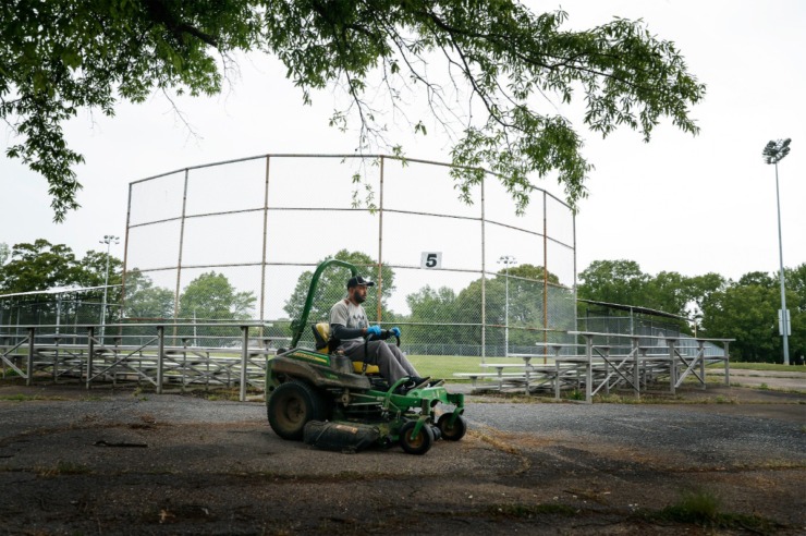 <strong>Memphis Little League president Kerry Cobb rides a lawn mover after cutting outfield grass on April 22, 2020, at Will Carruthers Park.</strong> (Mark Weber/Daily Memphian)