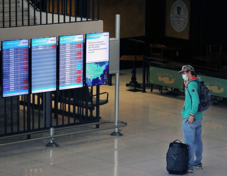 <strong>A lone passenger checks the flight information display system with roughly two dozen canceled flights at the Memphis International Airport April 23, 2020.</strong> (Patrick Lantrip/Daily Memphian)