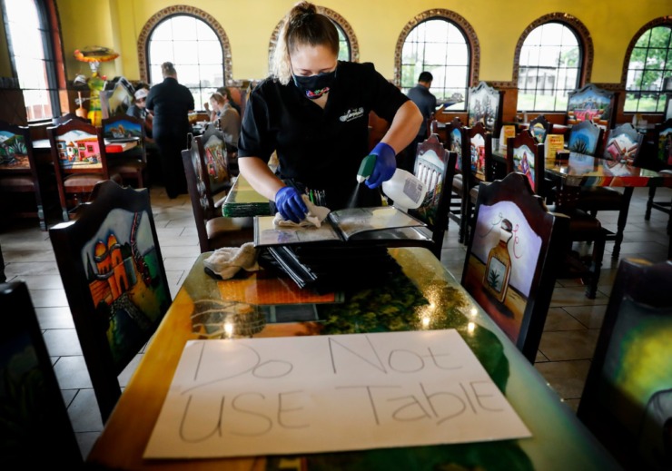 <strong>Margaritas weaver Kyra Nava disinfects menus during lunch on Monday, April 27, 2020, in Munford.</strong> (Mark Weber/Daily Memphian)