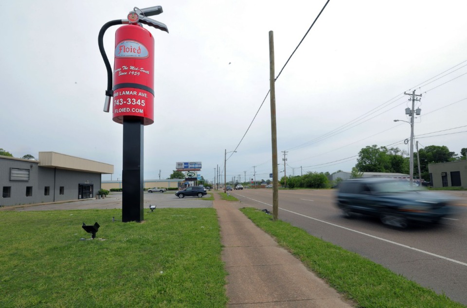 <strong>Cars whiz down Lamar near Memphis fire extinguisher company Floied's new 35-foot tall sign April 27, 2020. Floied had the fire extinguisher made by Williams Sign Company.</strong> (Patrick Lantrip/Daily Memphian)