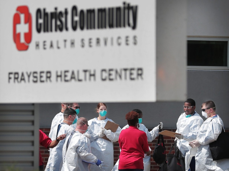 <strong>Christ Community staff, medical technicians and National Guard medics prepare to start a long day of COVID-19 testing as hundreds of Memphians line up at the Christ Community testing site in Frayser on April 25, 2020.</strong> (Jim Weber/Daily Memphian)