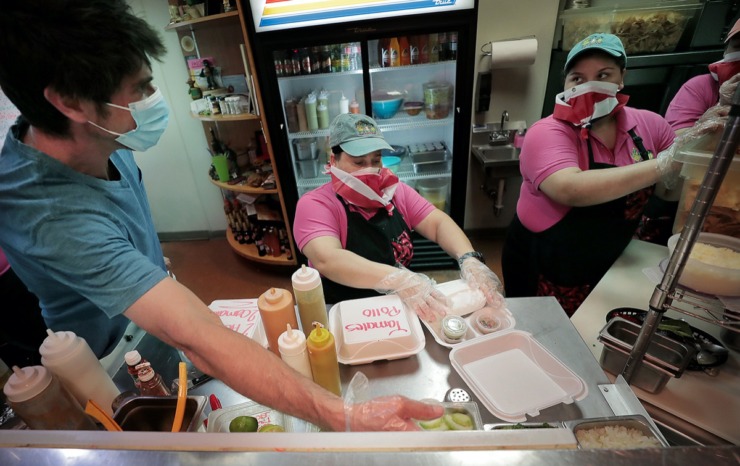 <strong>Jonathan Magallanes (left), Argentina Uceda and Eleida Gallegos prepare take-out orders as the popular Germantown eatery Las Tortugas reopens on April 28, 2020, with curbside service.</strong><span> (Jim Weber/Daily Memphian)</span>
