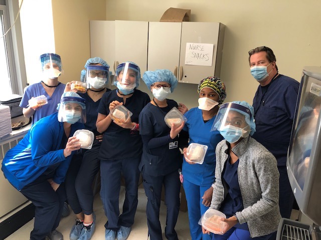 <strong>Covered in PPE, nurses at Roosevelt Island Medical Center claim snacks and lunches from donations sent by citizens of Byhalia, Mississippi. Nurse Todd Maxwell (back right) has volunteered his time and expertise to Roosevelt during the emergency.</strong> (Submitted)