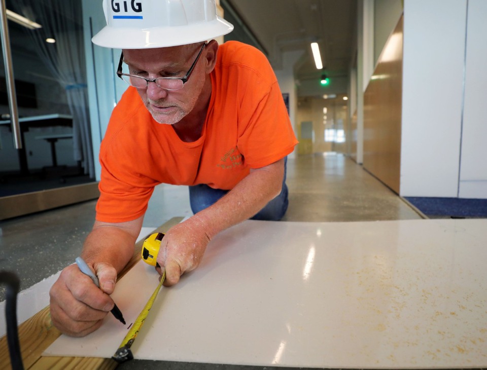<strong>Phillip Michael Hunt with Grinder, Taber and Grinder measures a piece of plexiglass to be installed into A Step Ahead foundation's Crosstown Concourse office April 27, 2020.</strong> (Patrick Lantrip/Daily Memphian)
