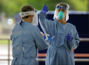 <strong>A doctor pulls out a fresh testing swab before administering a COVID-19 test at Christ Community Health's drive-thru COVID-19 testing site in Whitehaven April 13, 2020.</strong> (Patrick Lantrip/Daily Memphian)