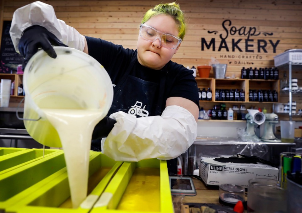 <strong>Buff City Soaps employee Elizabeth Schrader pours liquified soap into a moving dish on Tuesday, April 28, 2020, in Olive Branch.</strong> (Mark Weber/Daily Memphian)