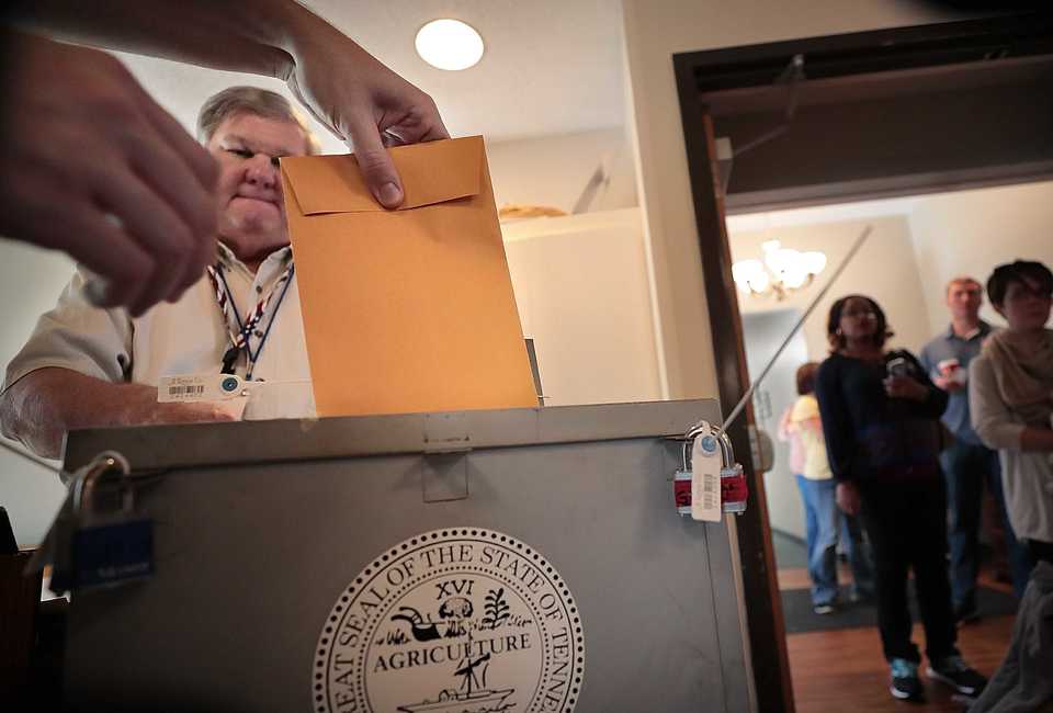 <strong>Chase Wyatt casts a paper vote under the watchful eye of election officer Lenard Grice at Riveroaks Reformed Presbyterian Church in Germantown on Nov. 6. The Shelby County Election Commission certified the results Monday, though questions remain about provisional ballots.</strong> (Jim Weber/Daily Memphian)
