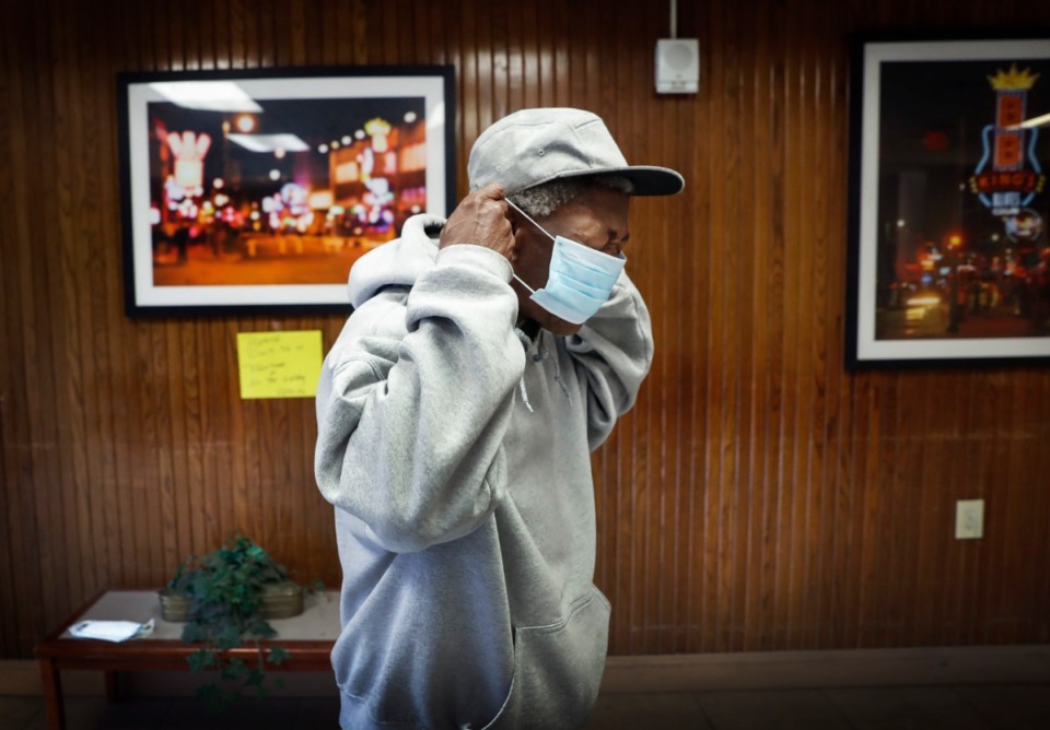 <strong>Memphis Housing Authority resident Roscoe Wells puts on a donated face mask on Thursday, April 23, 2020 at Dr. R.Q. Venson Center Apartments.</strong> (Mark Weber/Daily Memphian)