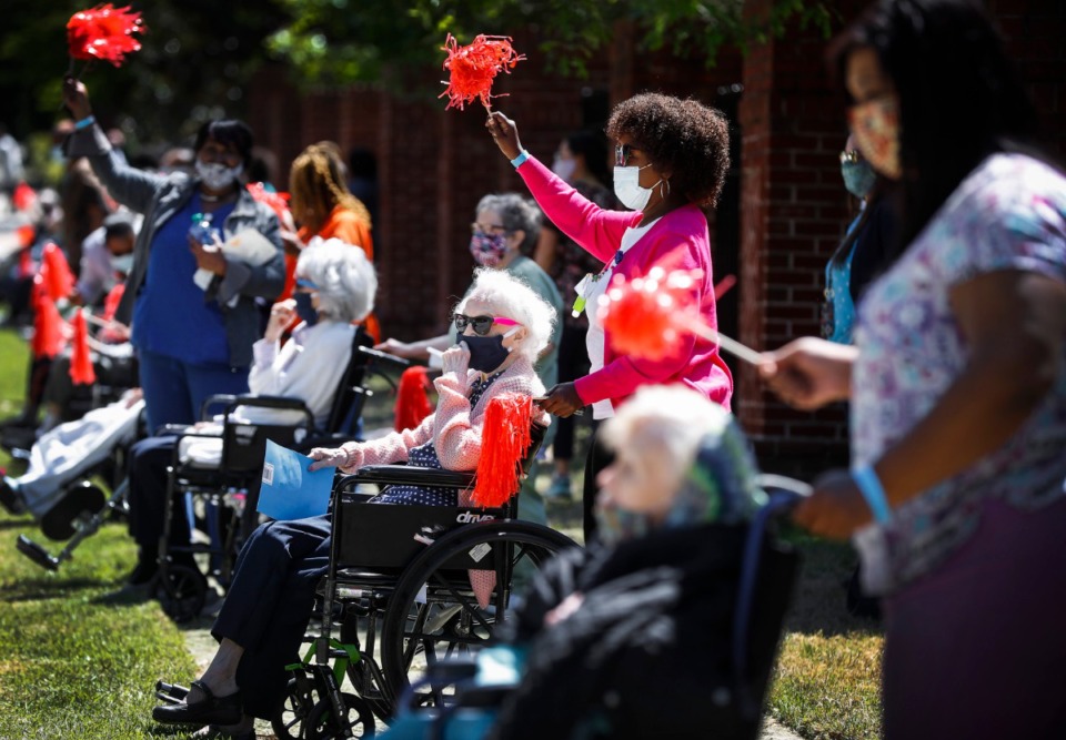<strong>Assisted living and skilled nursing residents from Trezevant Manor wave to family members, who paraded by them on April 30, 2020. Residents from the Midtown retirement community have not seen family members since the facility went on lockdown due the COVID-19 outbreak.</strong> (Mark Weber/Daily Memphian)