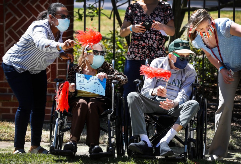 <strong>Assisted living and skilled nursing residence from Trezevant Manor wave to family members who paraded by them on April 30, 2020. Residents from the Midtown retirement community have not seen family members since the facility went on lockdown due the COVID-19 outbreak.</strong> (Mark Weber/Daily Memphian)
