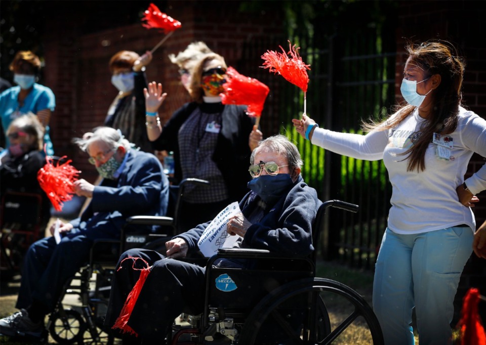 <strong>Assisted living and skilled nursing residents from Trezevant Manor wave to family members who paraded by them on April 30, 2020. Residents from the Midtown retirement community have not seen family members since the facility went on lockdown due the COVID-19 outbreak.</strong> (Mark Weber/Daily Memphian)