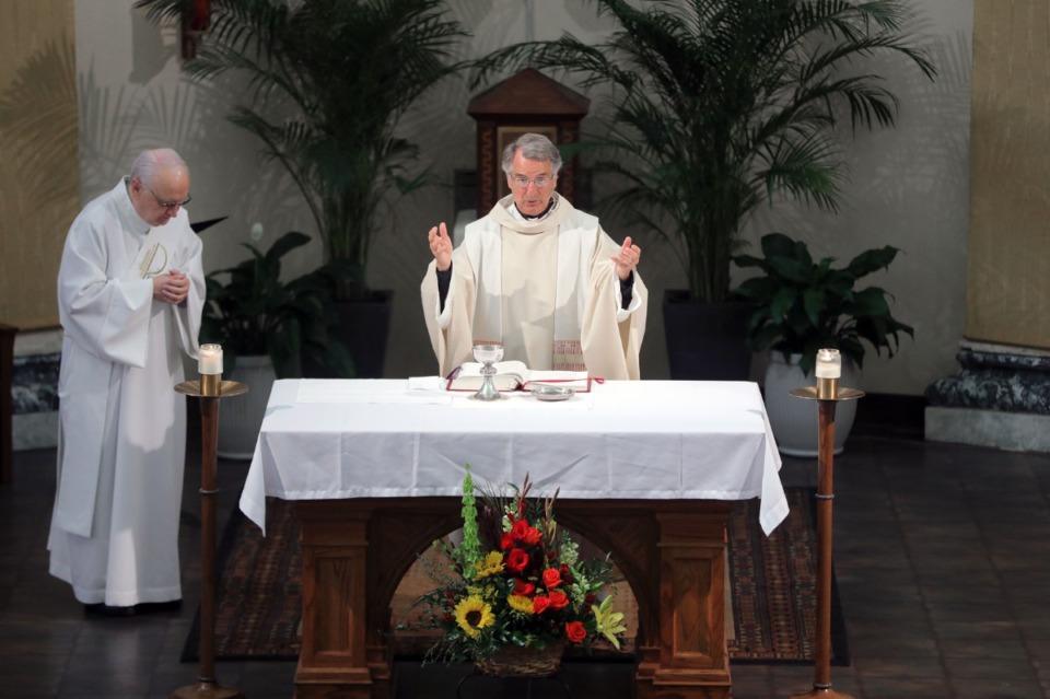 <strong>Monsignor Val Handwerker blesses the Eucharist during a virtual mass at St. Patrick Catholic Church May 3, 2020.</strong> (Patrick Lantrip/Daily Memphian)
