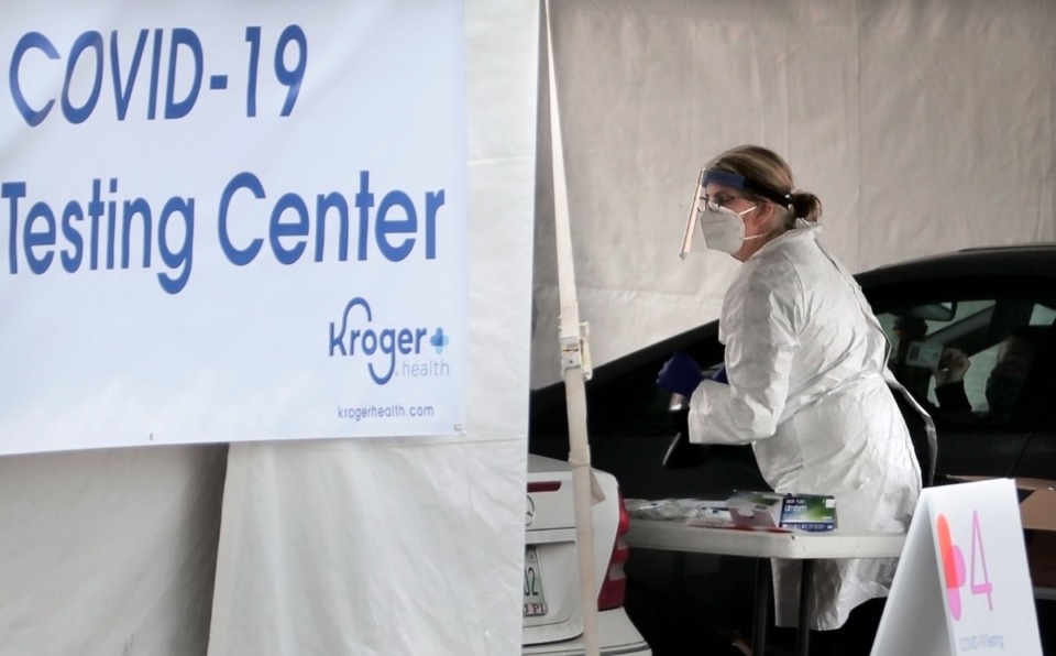 <strong>Medical technicians and nurses collect samples as staff from Cherokee Health and Kroger team up to offer a limited 3-day run of free drive-thru COVID-19 testing for people with symptoms, healthcare workers and first responders in the parking lot at the Memphis Business Academy in Frayser on April 22, 2020.</strong> (Jim Weber/Daily Memphian)