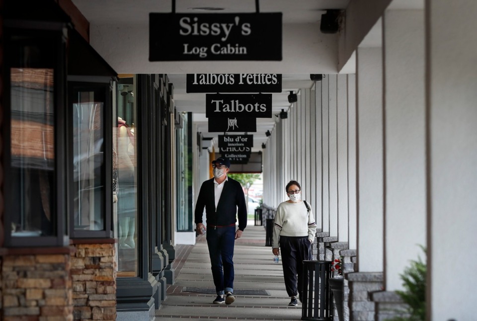 <strong>A couple stroll past closed stores at the Laurelwood Shopping Center on Monday, May 4, 2020. Retailers like clothing stores, boutiques and other non-essential businesses that have been closed down for newly eight-weeks, were allowed to open during Phase One of the city&rsquo;s and county&rsquo;s Back-to-Business Framework.</strong> (Mark Weber/Daily Memphian)