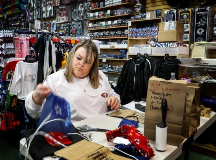 <strong>"It feels great to reopen," said TNC Sports assistant manater Tammy Connolly, finishing a sports-themed face mask on Monday, May 4, 2020 in Bartlett.</strong> (Mark Weber/Daily Memphian)