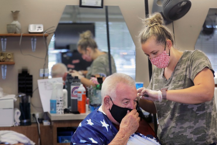 <strong>Sam Lingua (left) gives Robert Frailey Sr. a haircut at Stage Road Barber Shop in Bartlett May 6, 2020.</strong> (Patrick Lantrip/Daily Memphian)