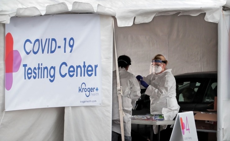 <strong>Medical technicians and nurses collect samples as staff from Cherokee Health and Kroger team up to offer a limited 3-day run of free drive-thru COVID-19 testing for people with symptoms, healthcare workers and first responders in the parking lot at the Memphis Business Academy in Frayser on April 22, 2020.</strong> (Jim Weber/Daily Memphian)