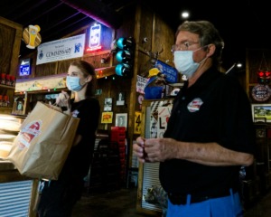 <strong>Commissionary BBQ owner Walker Taylor (right) and employee Haven Wilson deliver orders to carry-out customers at the restaurant's Collierville location on Sunday, May 10.</strong> (Ziggy Mack/Special to Daily Memphian)