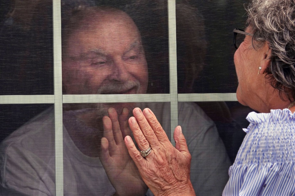 <strong>Angela Capocaccia visits her husband Richard through a window at the Ave Maria Home in Bartlett where he is being cared for. Family members are not allowed to enter the facility at this time due to social distancing rules.</strong>&nbsp;(Karen Pulfer Focht/ Special to Daily Memphian)