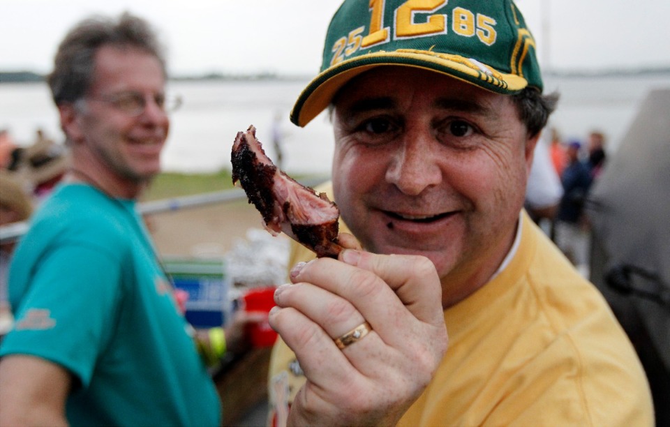 <strong>A member of the AdRibbers Team shows off a rib during the opening day of the Memphis in May World Championship Barbecue Cooking Contest in 2018.</strong> (Daily Memphian file)&nbsp;