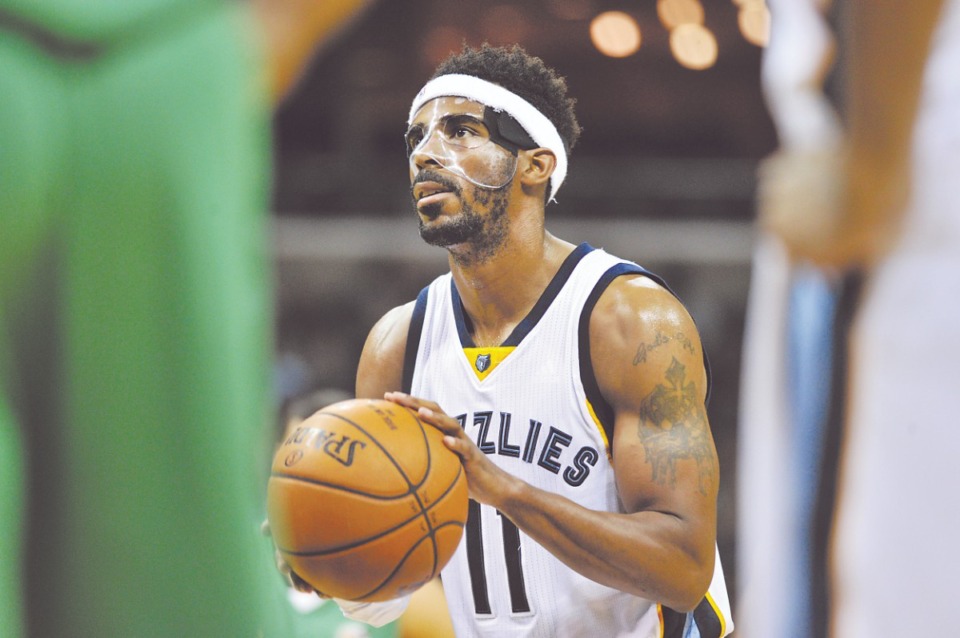 <strong>Memphis Grizzlies guard Mike Conley (11) takes the floor with a broken face and protective mask on Oct. 8, 2015, at FedExForum.</strong> (Brandon Dill/AP)