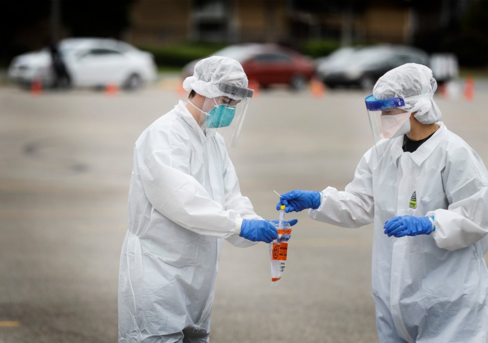 <strong>Christ Community Health Center medical staff collect nasal swabs as hundreds of Memphians line up for COVID-19 testing at their site in Hickory Hill on Tuesday, May 19, 2020</strong>. (Mark Weber/Daily Memphian)