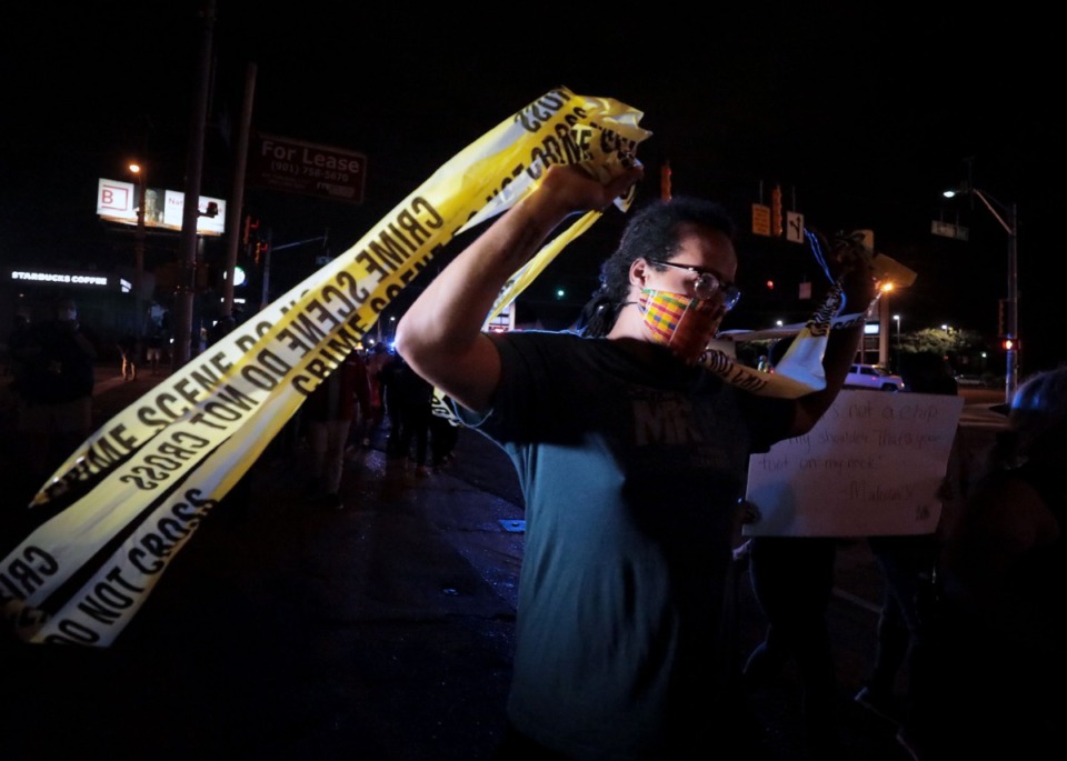 <strong>One protester held up police crime scene while marching down Union Avenue during a May 28, 2020 protest over the death of George Floyd.</strong> (Patrick Lantrip/Daily Memphian)