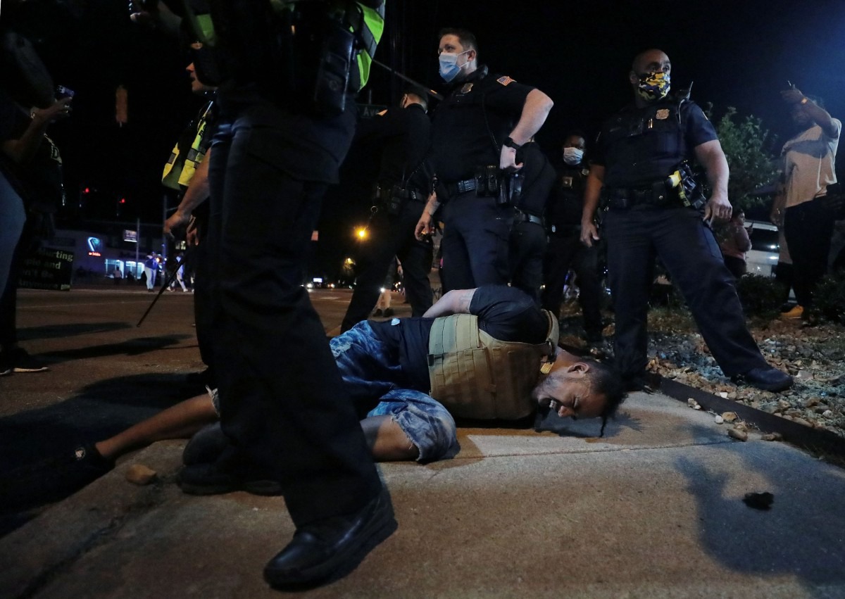 <strong>A protestor winces in pain after being pepper sprayed by Memphis police during a May 28, 2020 protest over the death of George Floyd.</strong> (Patrick Lantrip/Daily Memphian)