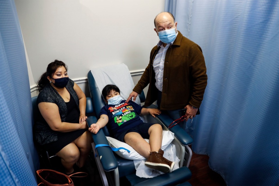 <strong>Dar Salud Care founder and CEO Dr. Pedro Velasquez-Mieyer (right) talks with patient Cristian Perez, 7 (middle), and his mother Yaquelin Herrera about the underlying cause for diabetes on Thursday, May 28, 2020. The clinic is moving from a for-profit model to a nonprofit model and rebranding to LifeDoc, but will remain a self-sustaining clinic.</strong> (Mark Weber/Daily Memphian)
