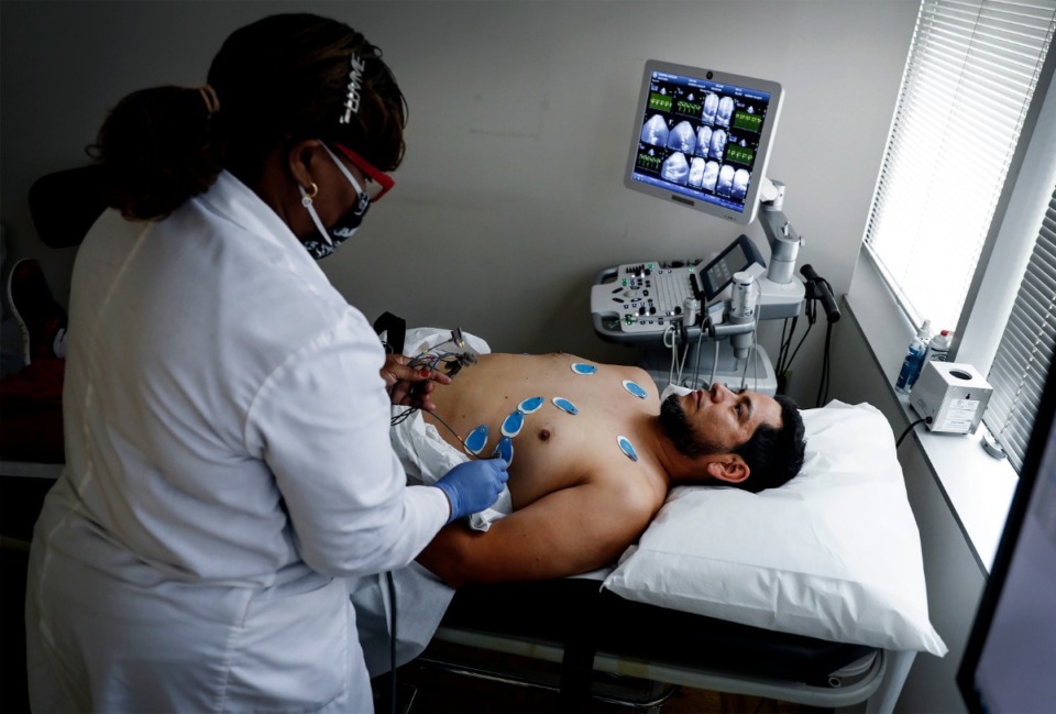 <strong>DarSalud Care nurse Freddie Webster (left) prepares patient Horacio Ramirez for a stress test on Thursday, May 28, 2020.</strong> (Mark Weber/Daily Memphian)