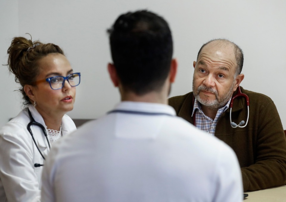 <strong>Dar Salud Care founder and CEO Dr. Pedro Velasquez-Mieyer (right) chats about patient care with team members Claudia Neria, Director of Clinical Practice (left), and Walid Mohammad, Director of Pharmacy, on Thursday, May 28, 2020.</strong> (Mark Weber/Daily Memphian)