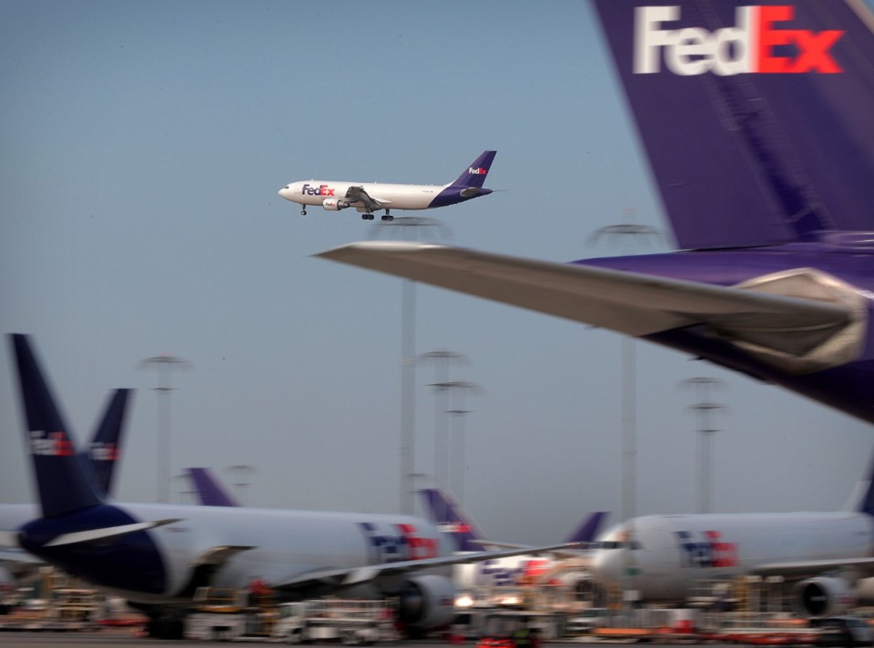 <strong>An incoming plane makes its final approach at the FedEx hub in 2019. The company has frozen share buybacks and its dividend in new credit agreements.</strong> (Jim Weber/Daily Memphian)