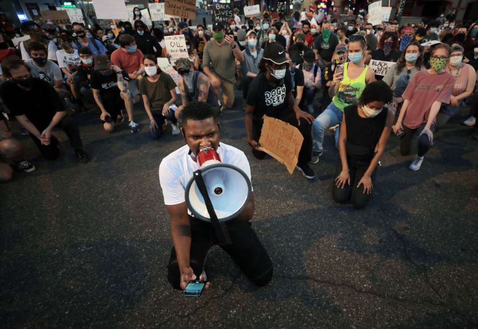 <strong>Devante Hill kneels in honor of George Floyd at the intersection Beale Street and B.B. King Boulevard during a Friday, May 29, march throughout Downtown Memphis to protest the murder of George Floyd by the Minneapolis Police.</strong> (Patrick Lantrip/Daily Memphian)