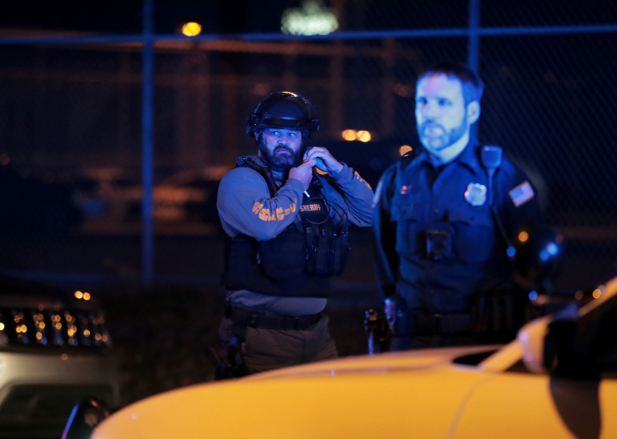 <strong>A Shelby County Sheriff's deputy puts on his riot gear while looking at group of protestors gathered outside of 201 Poplar May 31, 2020.</strong> (Patrick Lantrip/Daily Memphian)