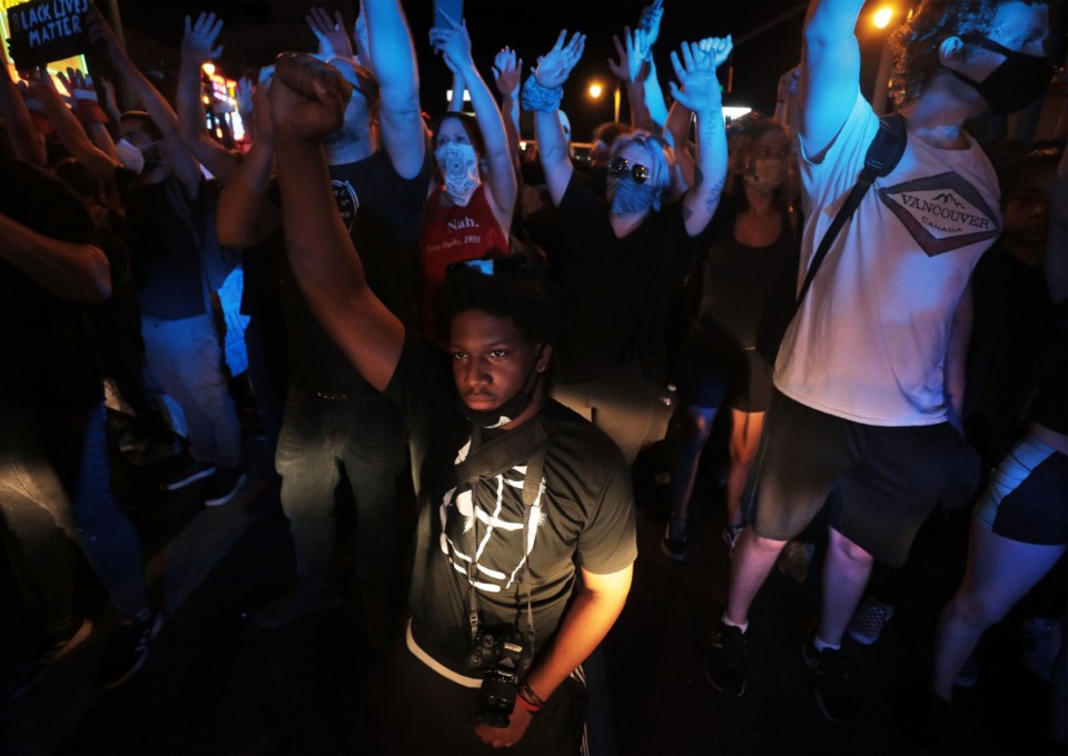 <strong>A protestor kneels in front of a line of police near Beale Street during a protest over the murder of George Floyd June 1, 2020.</strong> (Patrick Lantrip/Daily Memphian)