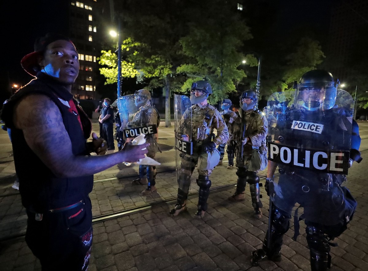 <strong>A protestors unsuccessfully asks the members of the National Guard to lower their weapons while protestors peacefully pass down Poplar Avenue Jiune 1, 2020.</strong> (Patrick Lantrip/Daily Memphian)