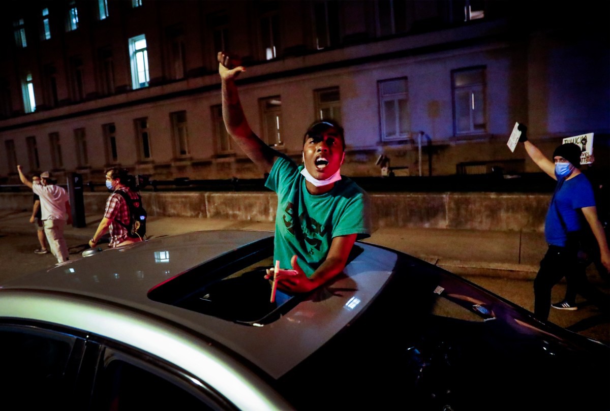 <strong>Jaz Flowers stand through her car&rsquo;s sunroof as protesters peacefully march by her in Memphis on Monday, June 1, 2020, during a protest over the Minneapolis killing of George Floyd.</strong> (Mark Weber/Daily Memphian)