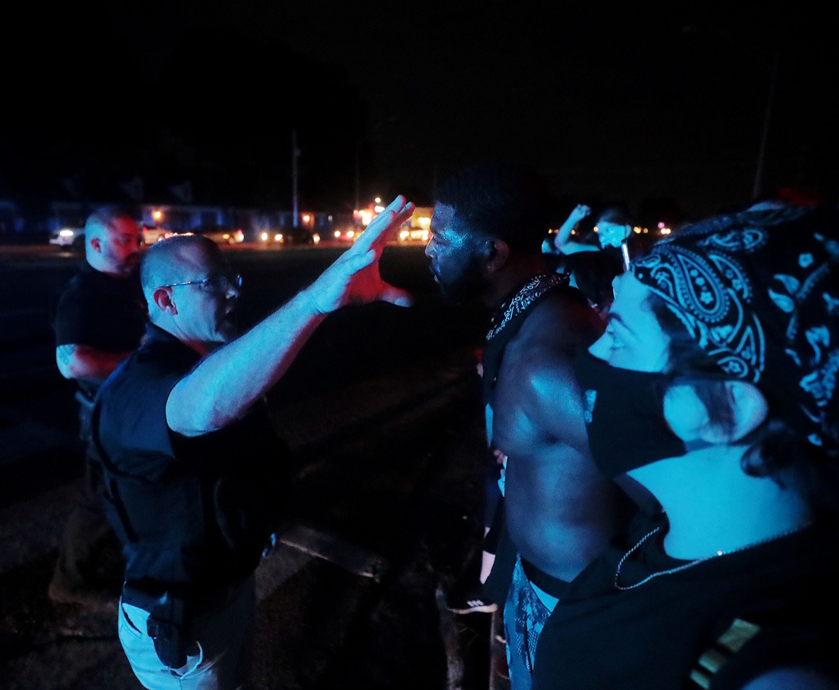 <strong>Darin Abston Jr. talks with a Memphis police officer after a protest shut down Germantown Parkway June 2, 2020.</strong> (Patrick Lantrip/Daily Memphian)