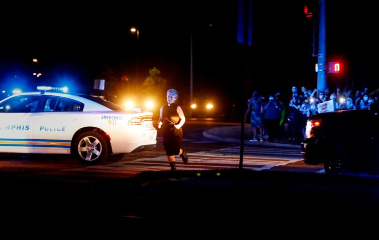 <strong>A protester runs past Memphis Police Department cars whlle crossing Germantown Parkway on Tuesday, June 2, 2020.</strong> (Mark Weber/Daily Memphian)