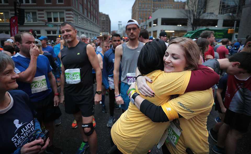 <strong>Nicole Johnson and Jill Bolden, both mothers of St. Jude patients, embrace before the start of the 5K race during St. Jude Memphis Marathon events on Saturday, Dec. 1, 2018. Despite two rain delays, more than 26,000 runners participated in the charity event, raising over $11 million for young cancer patients.</strong> (Jim Weber/Daily Memphian)