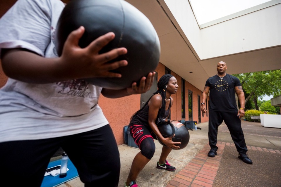 <strong>I Am Fitness Memphis owner and health/fitness coach Kelvin "York" Brown instructs LaToya Stingly and other clients in Whitehaven on Thursday, June 4. The fitness business received a $5,000 grant from the EDGE Economic Development Finance Committee.</strong> (Ziggy Mack/Special to the Daily Memphian)