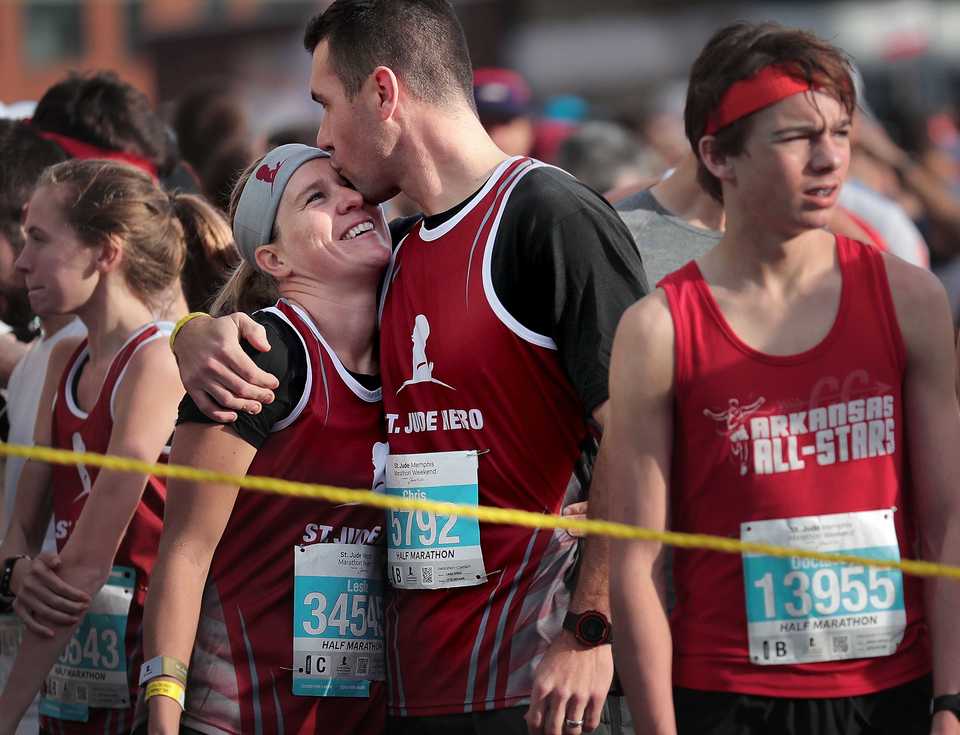 <strong>Chris Gillies and Leslie Gillies embrace before the start of the 17th annual St. Jude Memphis Marathon on Saturday, Dec. 1, 2018.Despite two rain delays, more than 26,000 runners participated in the charity event, raising over $11 million for young cancer patients.</strong>(Jim Weber/Daily Memphian)